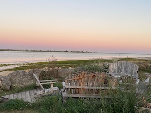 A beach with wooden structures and a view of the water.