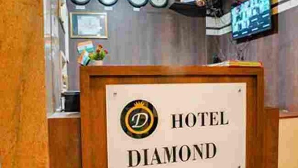 A reception desk with a sign that reads "HOTEL DIAMOND". - Diamond By Glitz Hotels (Mumbai)