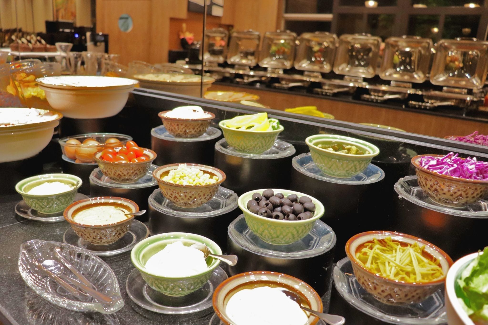 A buffet with various dishes and beverages.