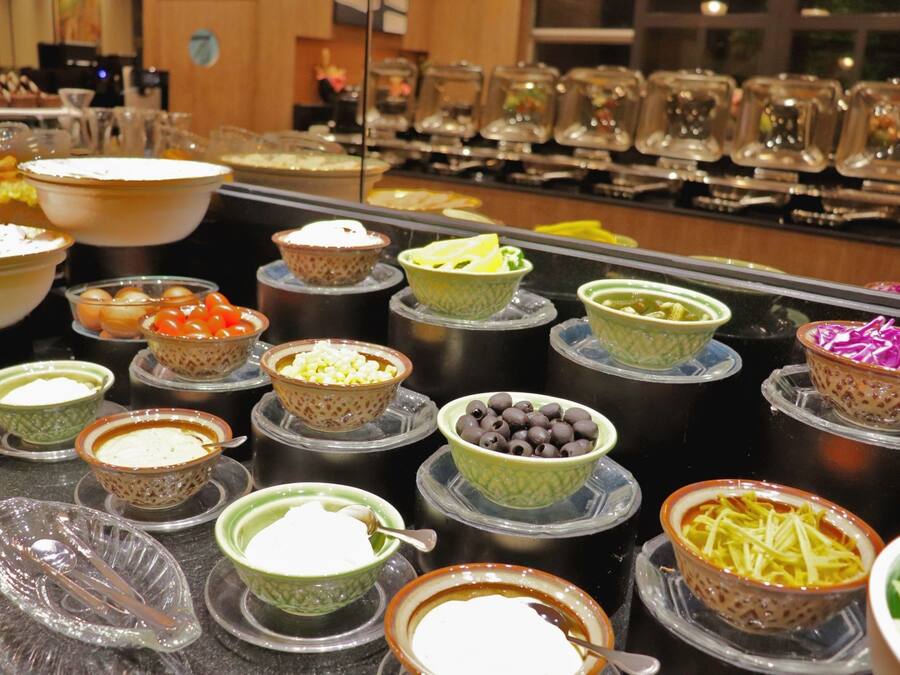 A buffet with various dishes and beverages.