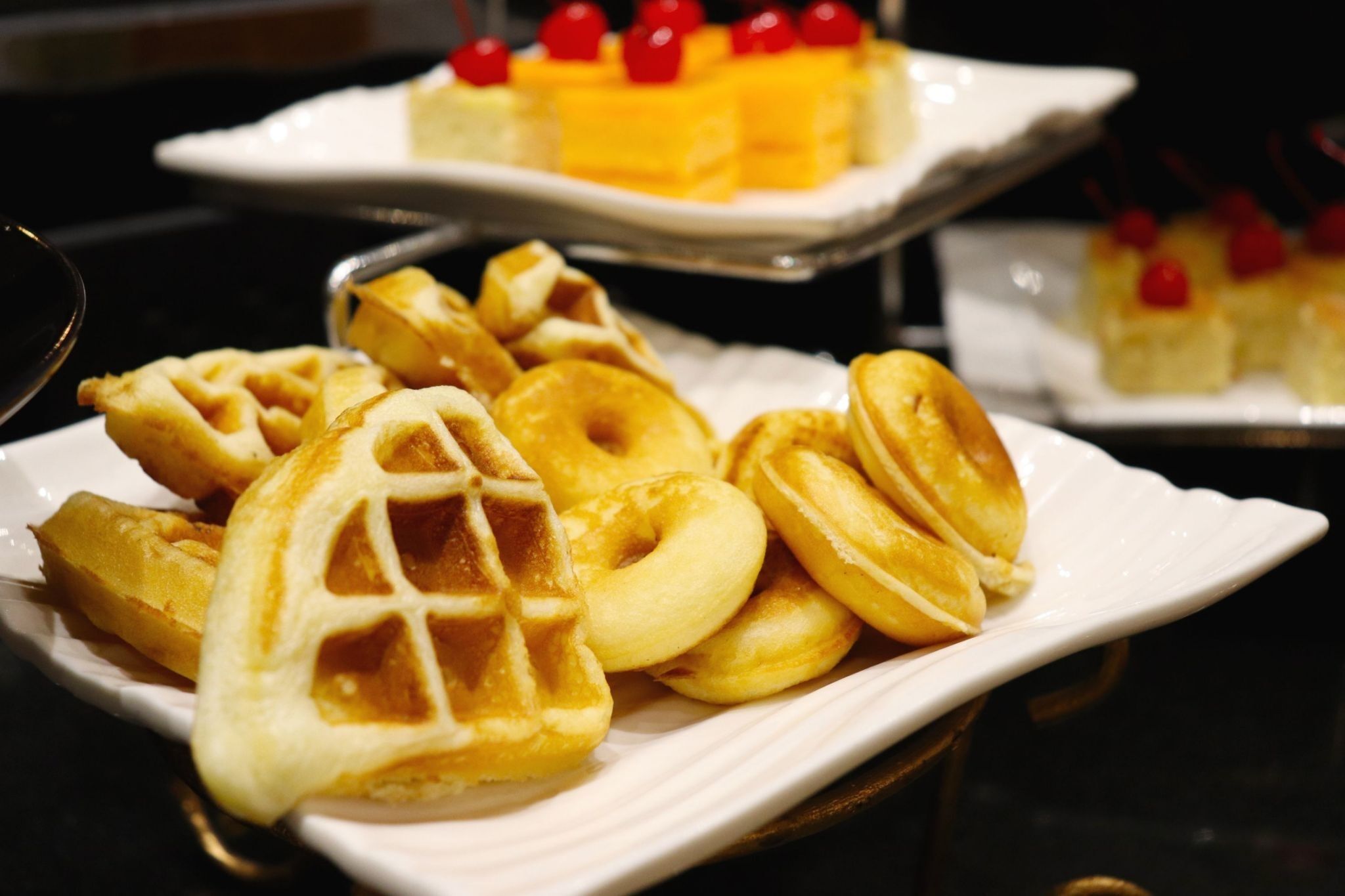 A plate of waffles with a waffle iron design on a white plate.