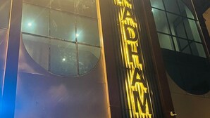 A building facade with illuminated signage, large windows, and a modern architectural design. - Hotel Shree Radham By GRB (Mathura)