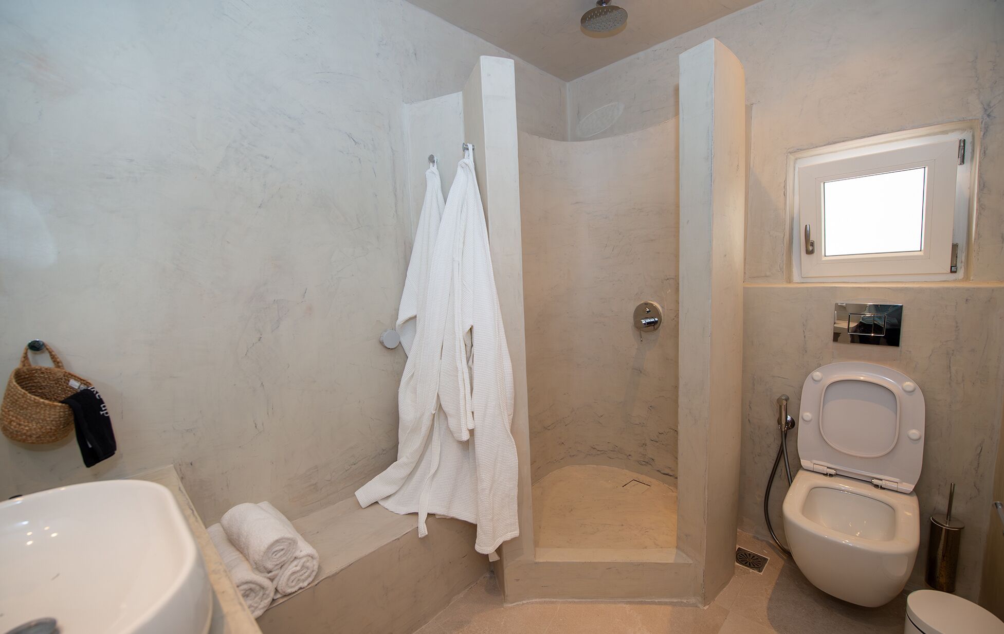 A bathroom with a shower, toilet, and sink.