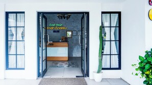 A hotel entrance with a reception desk, a chandelier, and a potted plant. - Hotel O Bandar Lampung Near Gor Saburai Formerly Omah Anakku (Bandar Lampung)