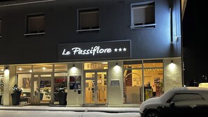 A hotel named "Le Passiflore" with a modern facade, large glass windows, and a visible entrance. - Logis Hôtel le Passiflore (Chateaubernard)