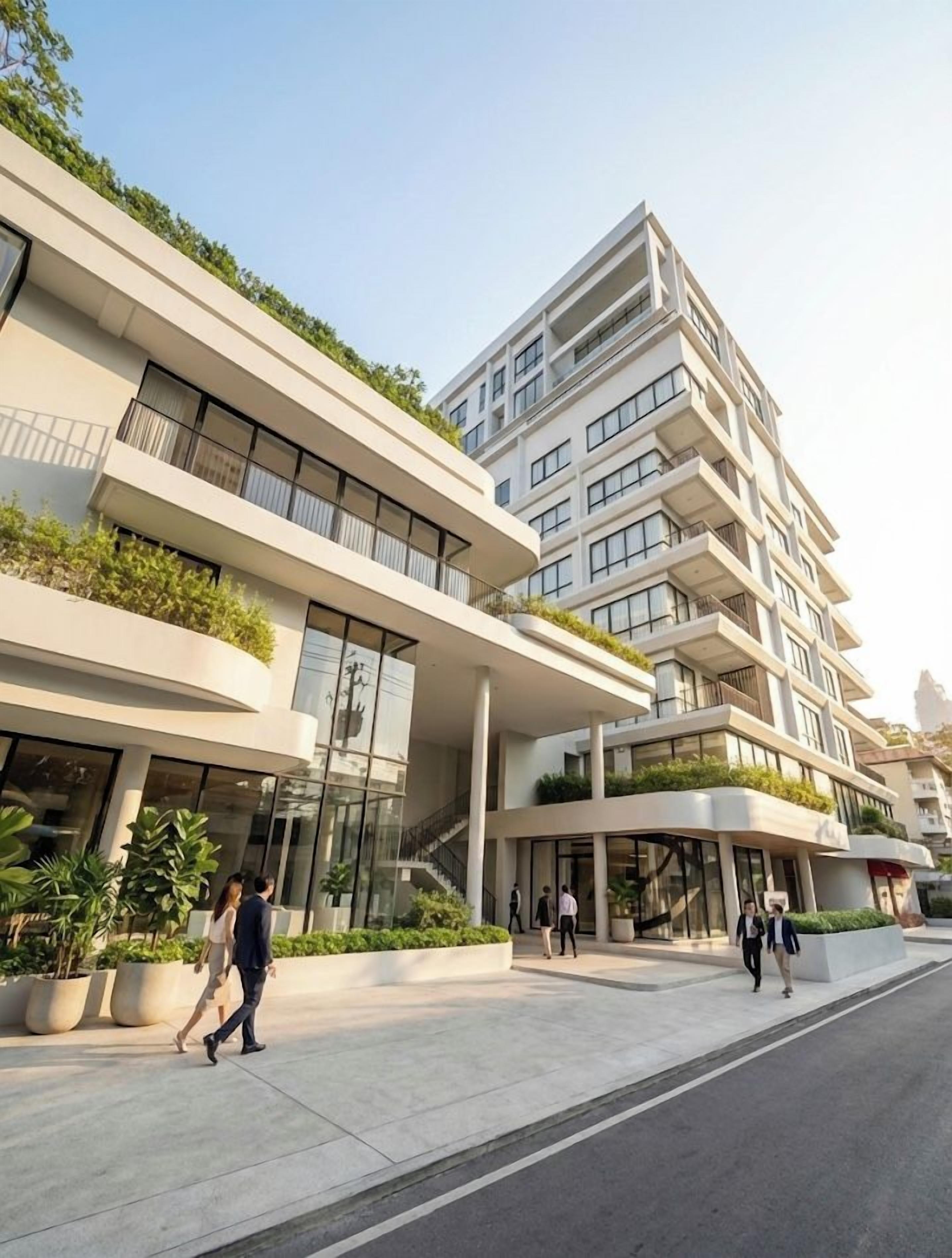 A multi-story building with a modern architectural design, featuring balconies and large windows.