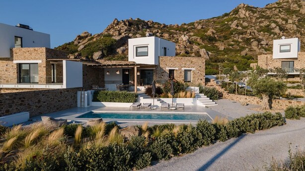 A modern villa with a pool, stone walls, and a mountainous backdrop. - Villa Andalusia, Orkos Naxos (Naxos)