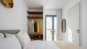 Una camera da letto con un letto, un armadio e una porta che dà su un balcone esterno.