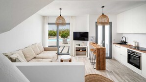 A modern apartment with a living room, kitchen, and a balcony with a pool view.