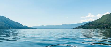 A calm lake with mountains on both sides.