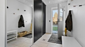 A modern bathroom with a white sink, a towel rack, and a shower area. - Beautiful home in Glesborg (Glesborg)