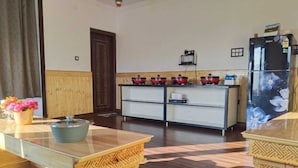 A kitchen with a wooden floor, a white refrigerator, and a stove. - Mount Vista Leh (Leh)