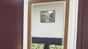 A wooden dresser with multiple drawers and a mirror above it. - Furnished Studio Appartment in Burdubai  (Dubai)