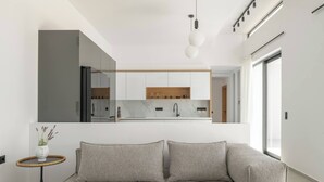 A modern living room with a sofa and a small side table with a vase.