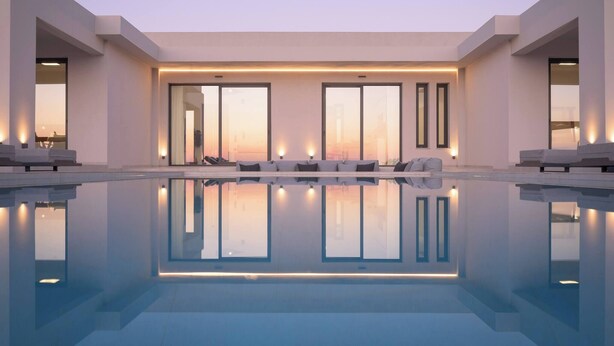 A modern pool area with a clear view of the sunset, large windows, and a minimalist design.