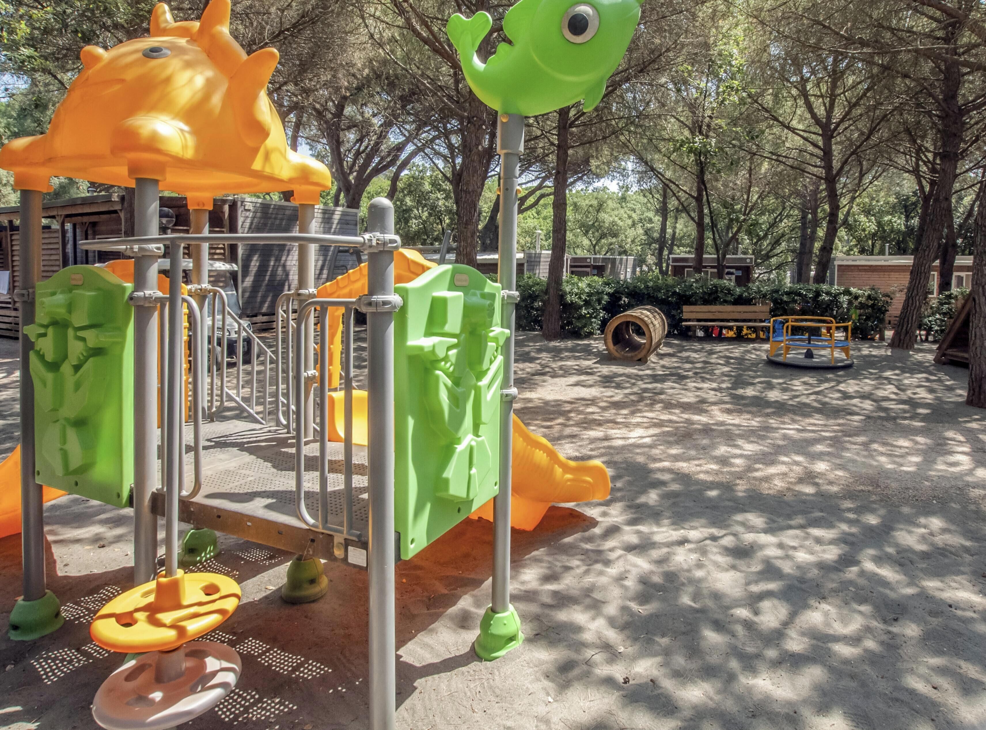 A playground with a climbing structure and a slide.