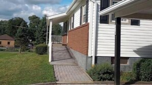 A single-story house with a brick exterior and a covered porch.