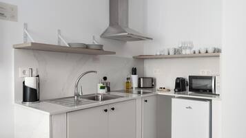 A modern kitchen with a built-in dishwasher, a microwave, and a coffee maker.