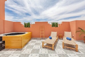 Relax on the rooftop with a soak in the hot tub, lounge on wicker chairs, and enjoy the view.