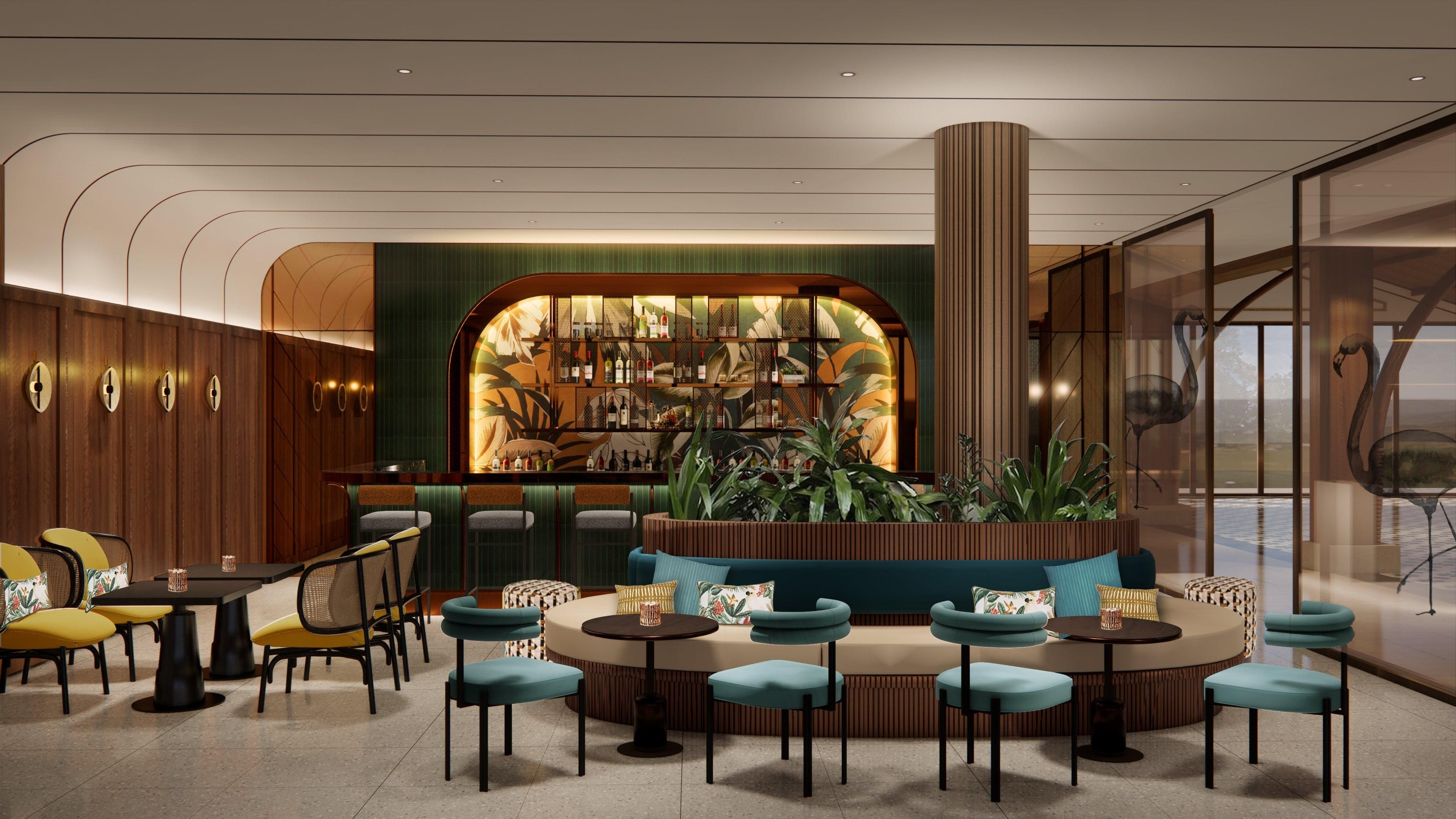 Uma área de estar moderna com bar, sofás e vista para o exterior.