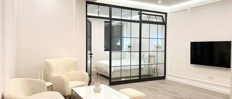 Deluxe Apartment, 1 Bedroom, Non Smoking, Kitchen | Living area | 65-inch LED TV with cable channels