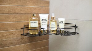 A bathroom shelf with body wash, lotion, and hand cream. - Luxury 1-bedroom apartment in Diamond in the City in Cantonments  (Accra)