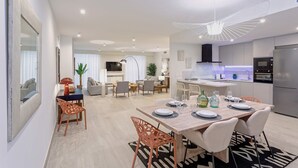 A modern kitchen with a built-in oven and a large refrigerator. - Genteel Home Teatro Gongora (Córdoba)