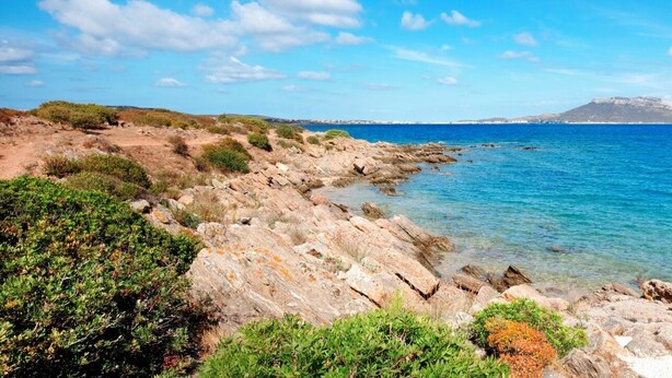 A rocky coastline with clear blue sea and distant islands. - Hotiday Golfo Aranci (Golfo Aranci)
