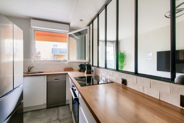 A modern kitchen with a dishwasher, stove, and sink.