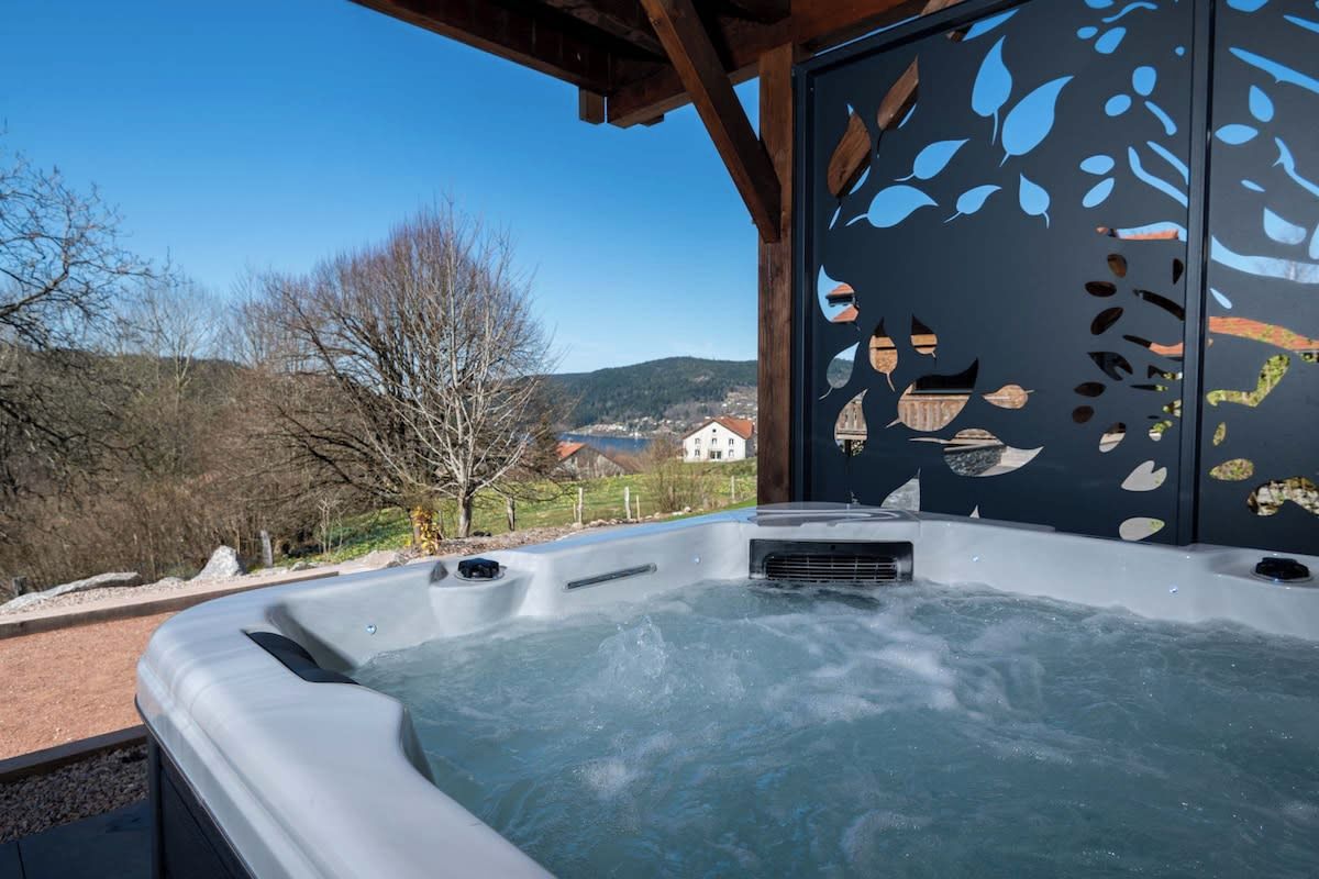 A hot tub with a view of a mountainous landscape.