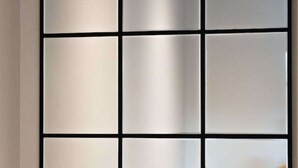 A wall with a grid of nine square panels.