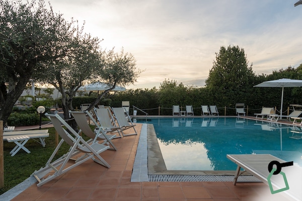 Seasonal outdoor pool, open 10:00 AM to 7:00 PM, pool umbrellas