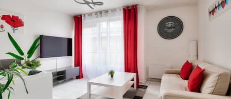 Deluxe Apartment, Garden View | Living area | 120-cm Smart TV with digital channels
