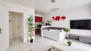 A modern apartment with a living room, kitchen, and dining area.
