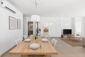 Enjoy meals in this spacious dining area with a long table and comfortable seating for all.