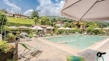 Seasonal outdoor pool, open 10:30 AM to 6:30 PM, pool umbrellas