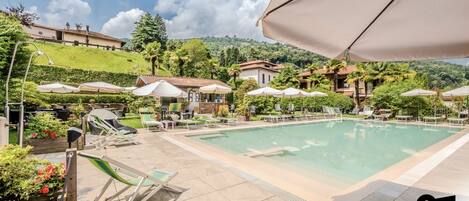 Seasonal outdoor pool, open 10:30 AM to 6:30 PM, pool umbrellas