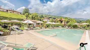 Seasonal outdoor pool, open 10:30 AM to 6:30 PM, pool umbrellas