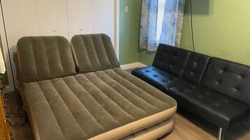 A room with a bed and a sofa.