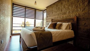 Suite Deluks, pemandangan kebun | 1 kamar tidur, tempat tidur bayi, dan tempat tidur lipat/tambahan