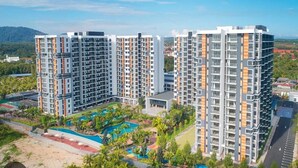 A high-rise residential building with multiple balconies, a swimming pool, and a landscaped garden area. - Timurbay Residence Resort Style (Kuantan)