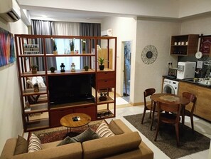 Family Condo, Sea View | Living area | Flat-screen TV