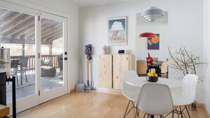 A modern kitchen with a dining area, a wooden cabinet, and a ceiling fan. - Contemporary Hudson Valley home (Staatsburg)