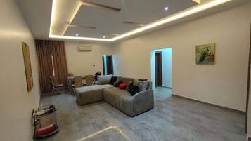 Family Apartment, Balcony, City View | Living area | Flat-screen TV