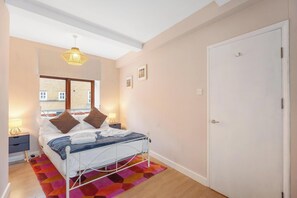 1 bedroom, desk, iron/ironing board, travel crib