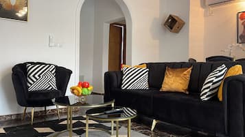 Standard Apartment, Garden View | Living area | TV