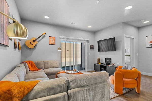 The Open Living Area is Filled with Natural Light and Boasts Chic Furnishings, Creating an Inviting Atmosphere for Both Relaxation and Entertainment.