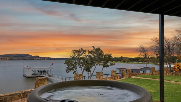 Un bain à remous avec vue sur un lac et sur le coucher de soleil.