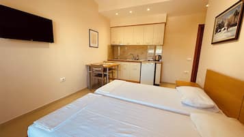 Economy Studio, 2 Twin Beds, Balcony, Partial Sea View | Desk, WiFi (free), bed sheets