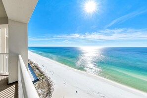 A balcony with a view of a beach and ocean. - Grand Panama 1-1807 (Panama City Beach)